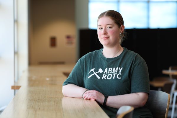 !Heather Hood poses for a photo in an ROTC shirt