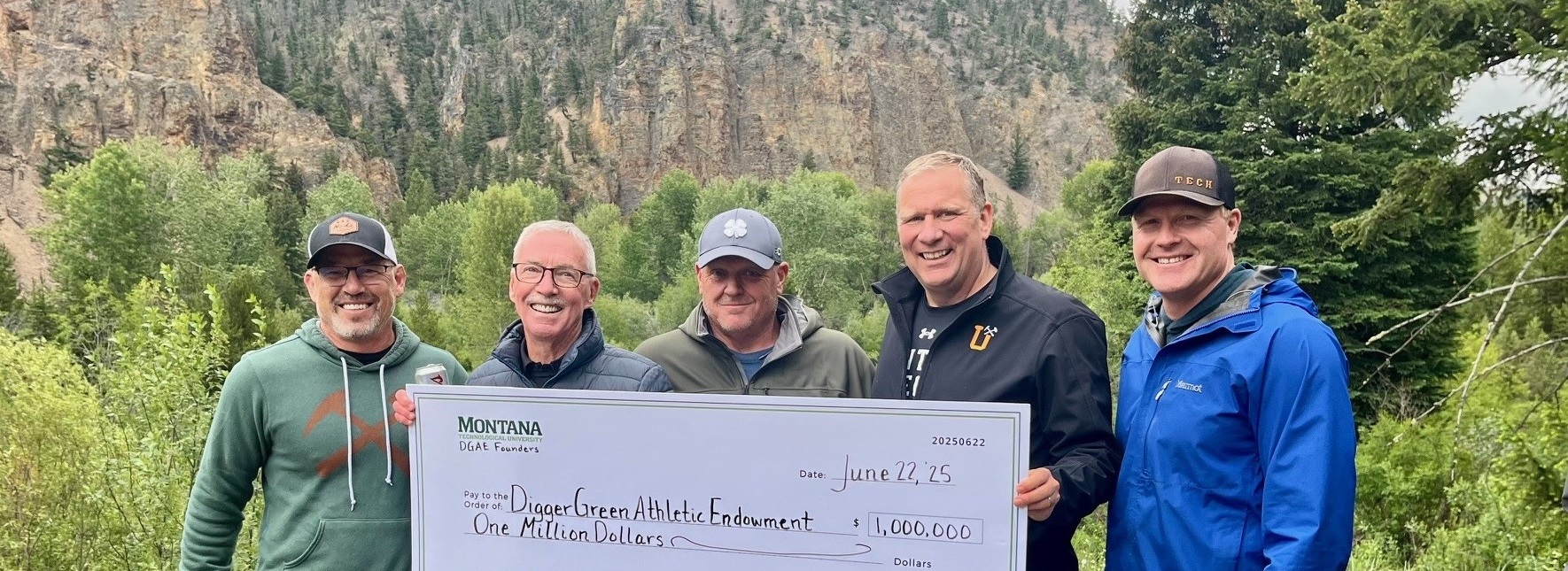 A group of donors pose with Coach Green and a $1.2 million check