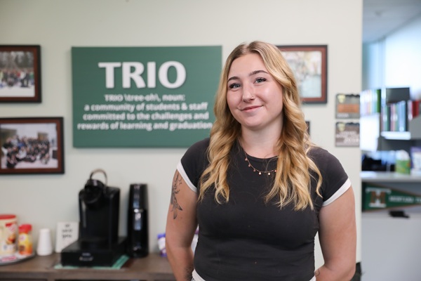 Lily Gordon in front of the TRIO sign. 
