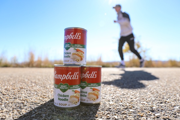 Cans of soup with a runner dashing behind