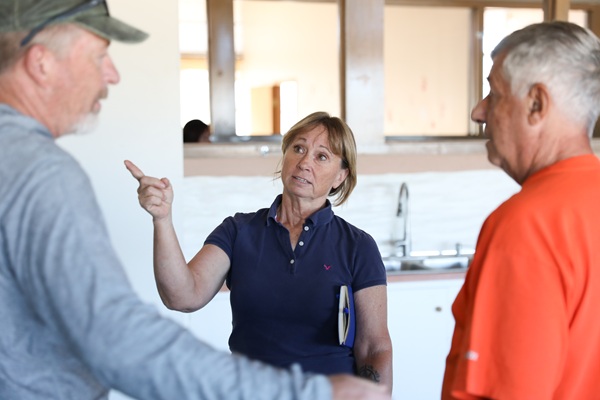 Robin Bullock speaks with two men in Blaine School