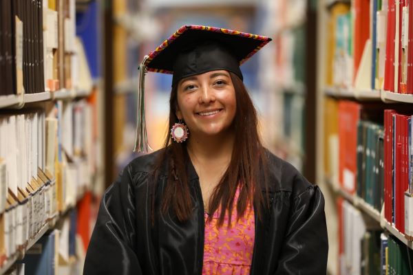 Rylee Mitchell poses for a photo in her beaded cap and gown