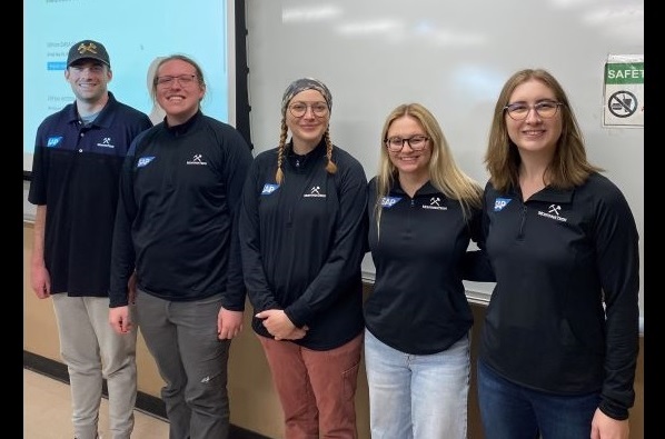 Five students in Montana Tech hoodies pose for a photo