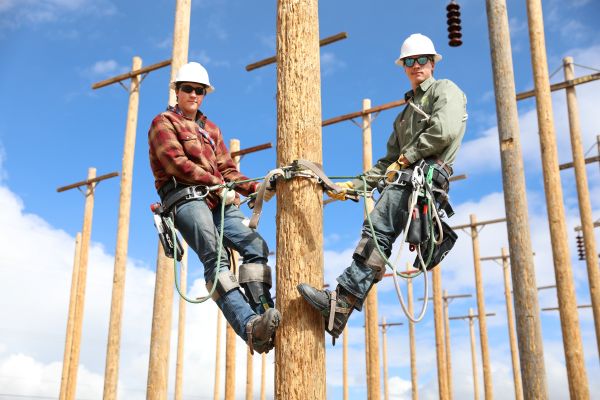 Two students pose for a photo in the pole yard