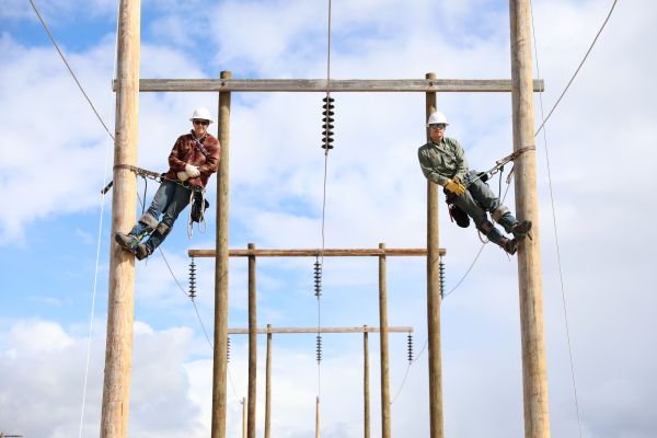 Two students pose for a photo in the pole yard.