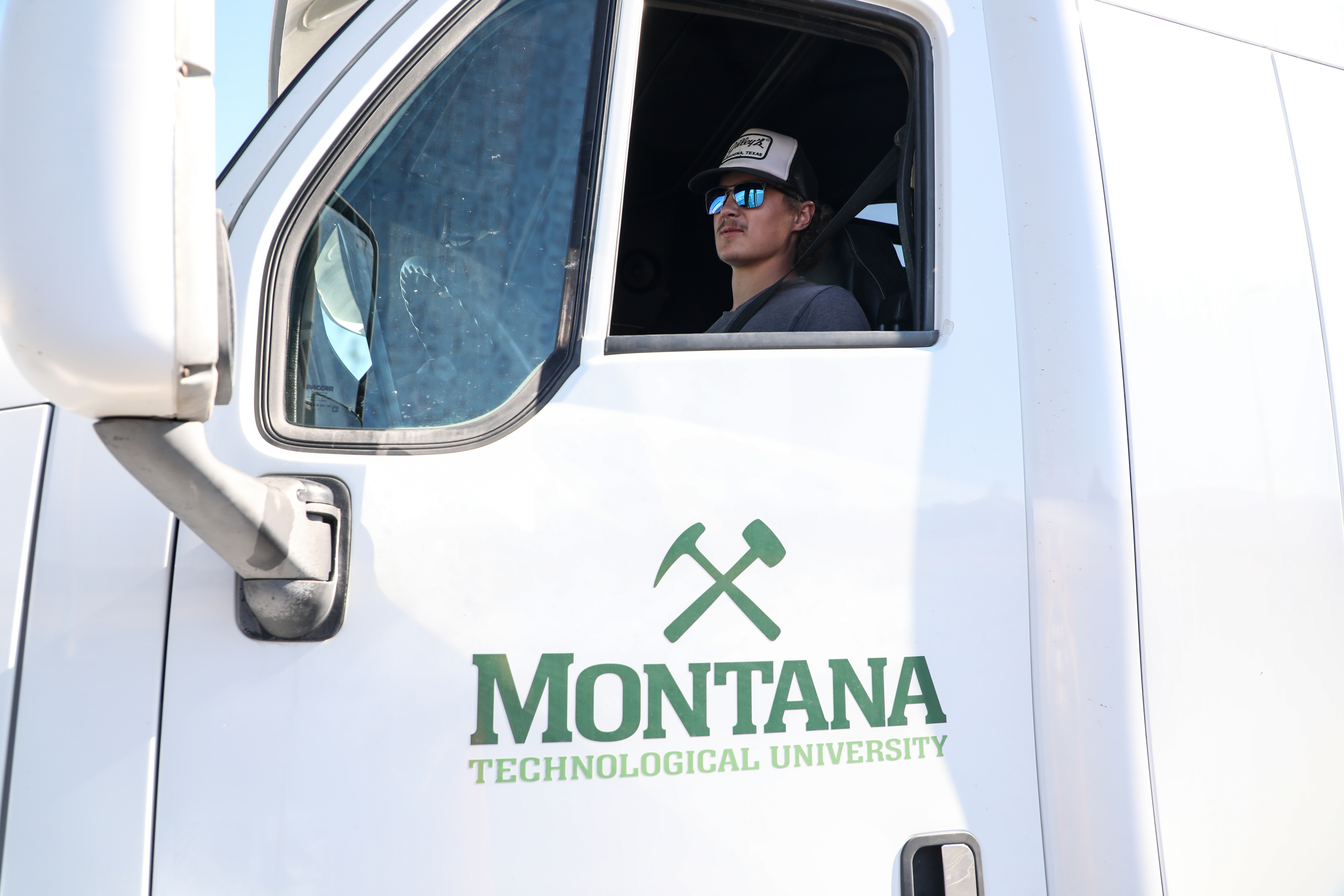 A student in the cab of a commercial vehicle
