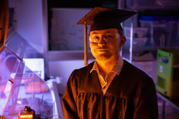 Jakob in his cap and gown in the clean room