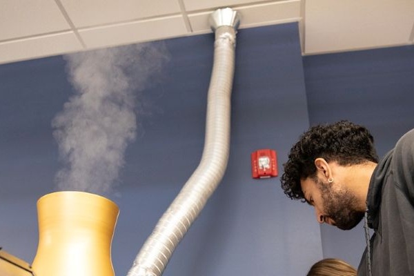 !a student works with a model cooling tower 