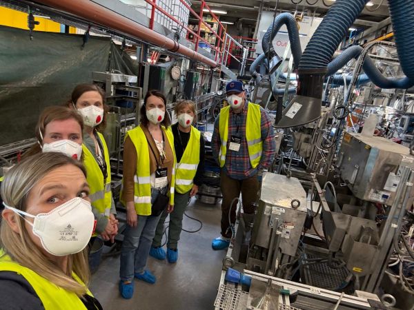 A group of six people in an industrial setting