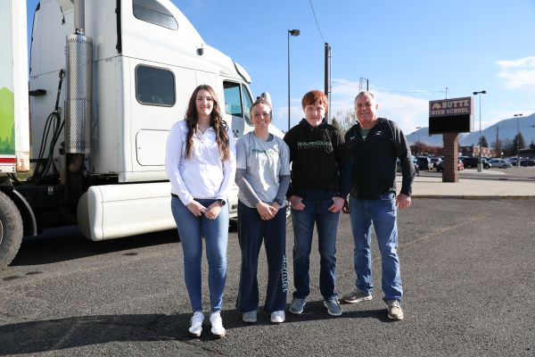 Students and Highlands College representatives pose for a photo in front of a commercial truck