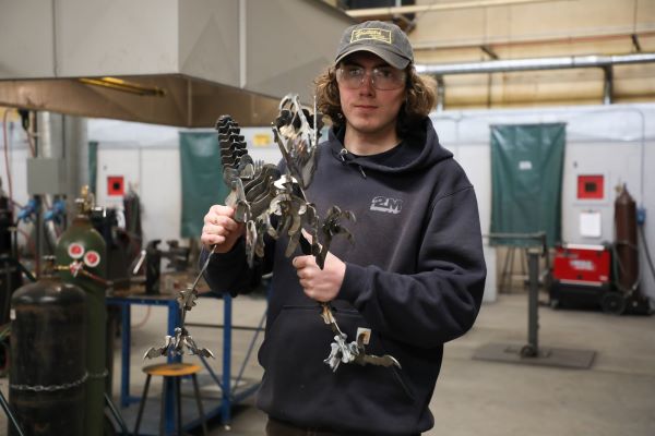 Student displays welded dinosaur