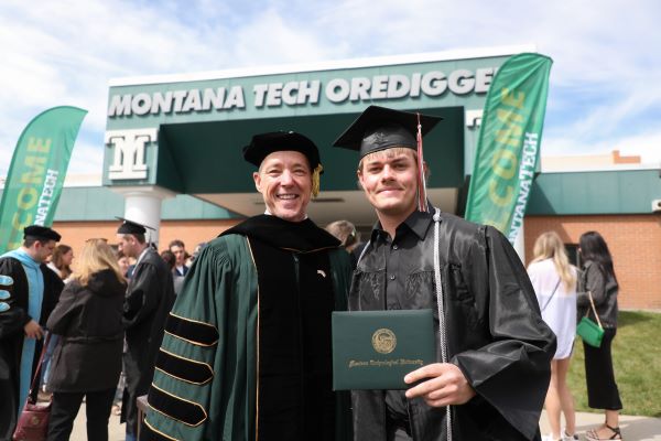 !Chancellor Cook poses with a student at graduation