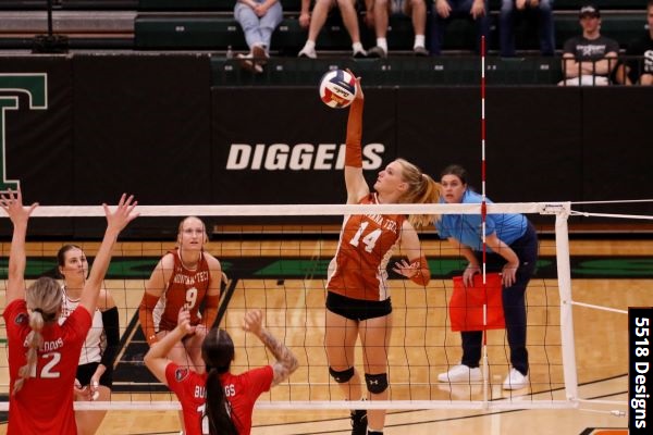 Volleyball player hits the ball across the net, with "5518 Designs" photo credit. 