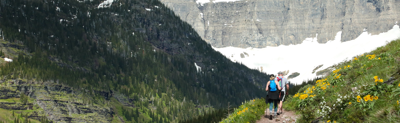 Two people hiking at Glacier National Park