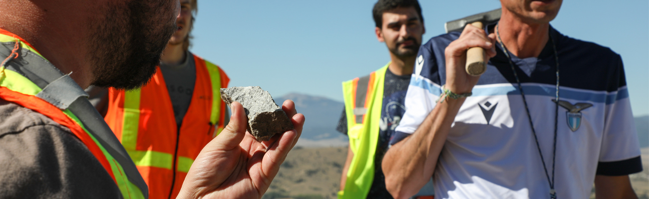 Student examining a rock