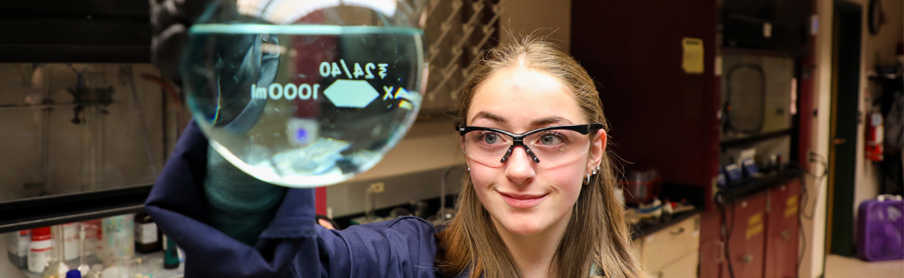 Student holding a glass beaker