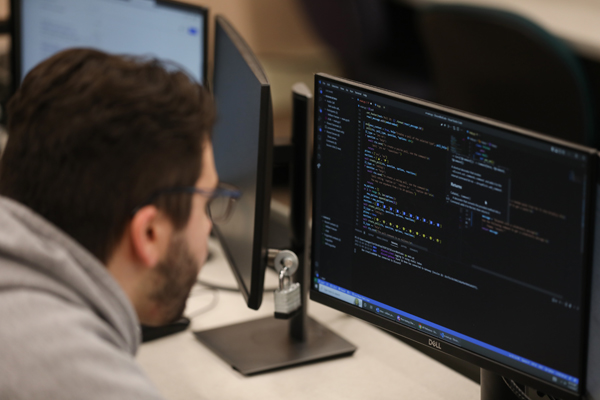 Man programming in a computer lab