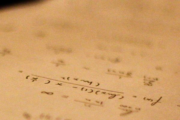 Written math equations on a piece of paper