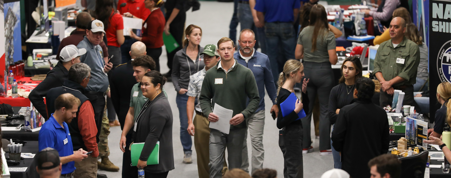 Crowd of people interacting with each other at a career fair.