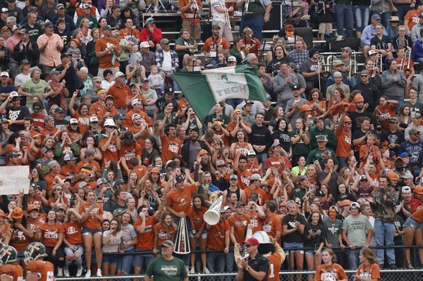 Crowd cheering at university football game