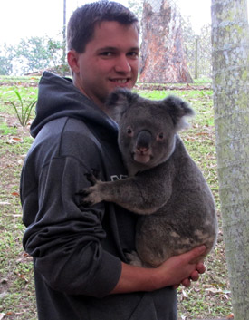 thesis abroad student in Australia holding a koala