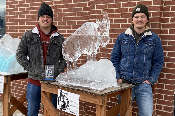 Heggem brothers with ice sculpture of mountain goat