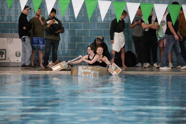 Students paddle a cardboard boat