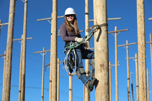 Misty Gittleson climbs a power pole