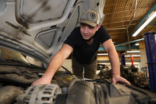 Cody West works on a vehicle