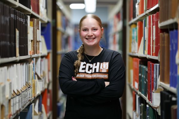 Tylar Clary poses for a photo in the library. 