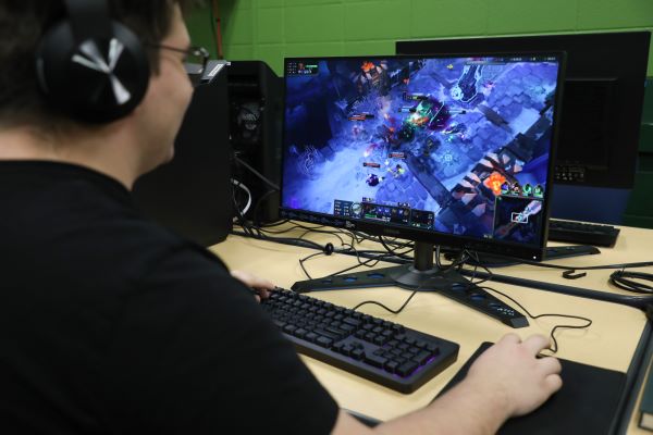 A student plays a video game in the Games Lab. 