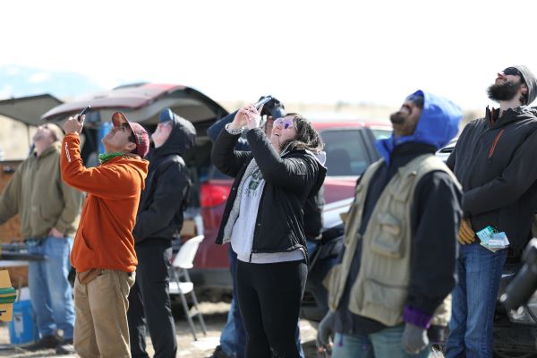 Students watch their rocket fly. 