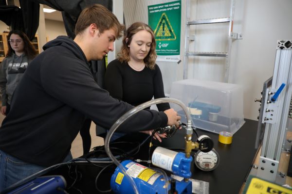 students test the integrity of a sealed N-95 mask