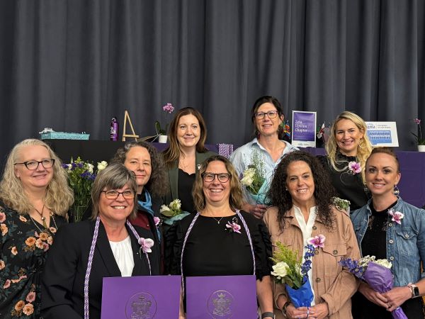 Montana Tech professors pose for a photo on stage