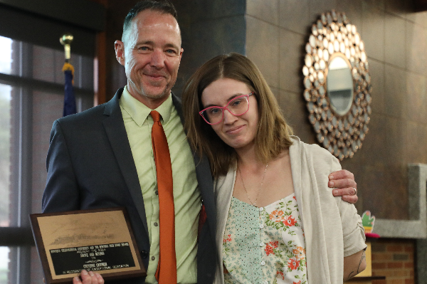 Chancellor Les Cook presents Cheyenne Crooker with an award