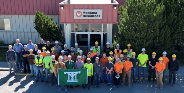 Group photo of the air of alumni and employees and university officials at Montana Resources
