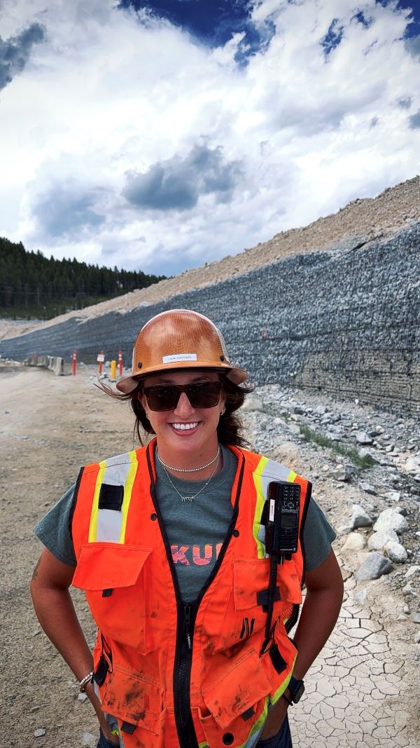 A student poses for a photo on the jobsite
