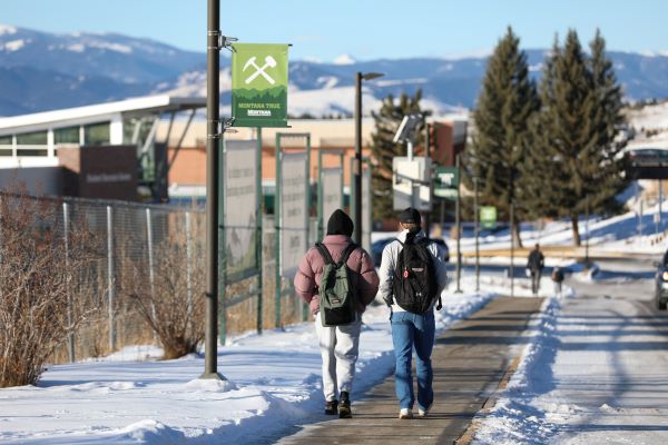 Two students walk on campus