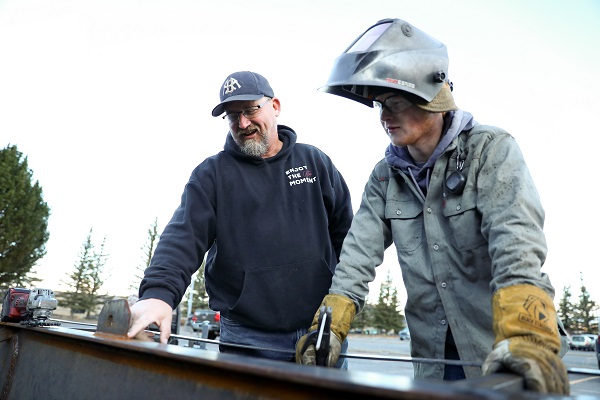 Instructor Jim LeProwse works with a welding student
