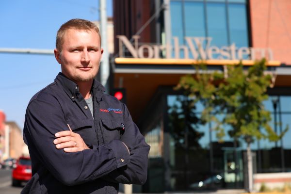 Nate Thompson in front of the NorthWestern Energy building