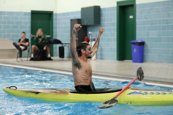 A student celebrates after successfully rolling in the kayak.