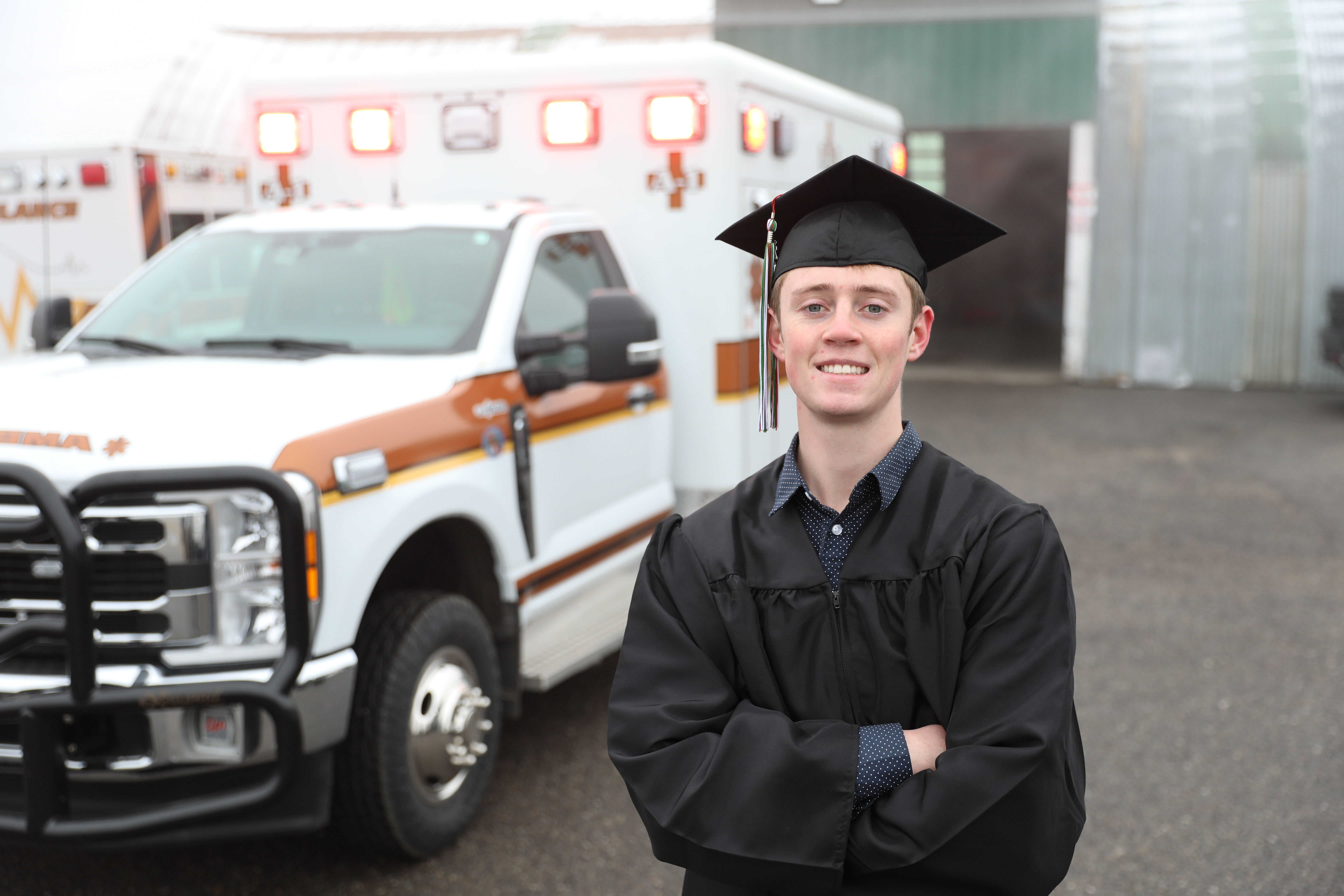 Trey Whitlock in front of an ambulance. 