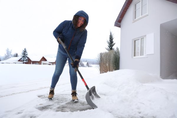 Dawn Anderson shovels a walk