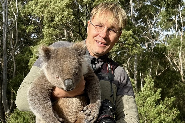 Ecological restoration professor Dr. Robert Pal holds a koala that he rescued from becoming roadkill.