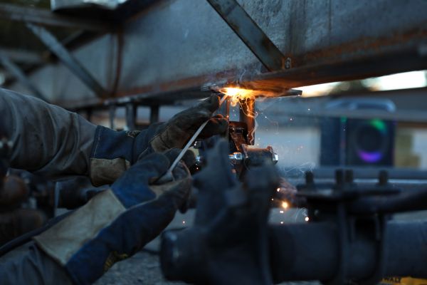 A welding student works on a trailer