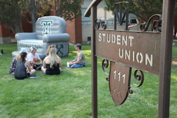 students lounge in front of the student union building