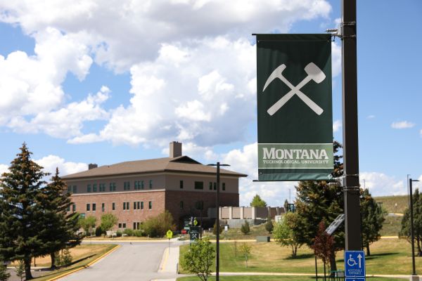 A Montana Tech banner with a campus building in the background. 
