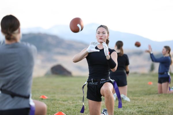 A student throws a football. 