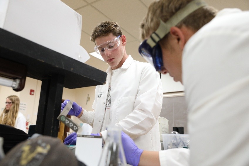 Campers test water-treatment prototypes in the lab as part of the Emergency at Granite Pass design challenge.