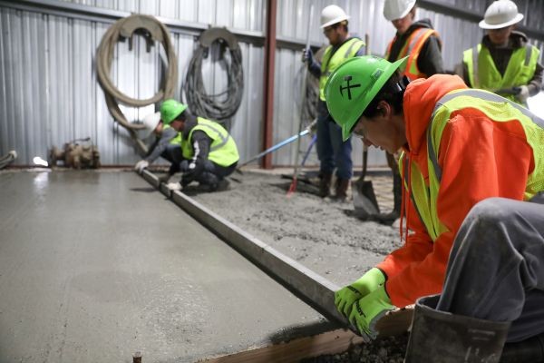 Students work with poured cement